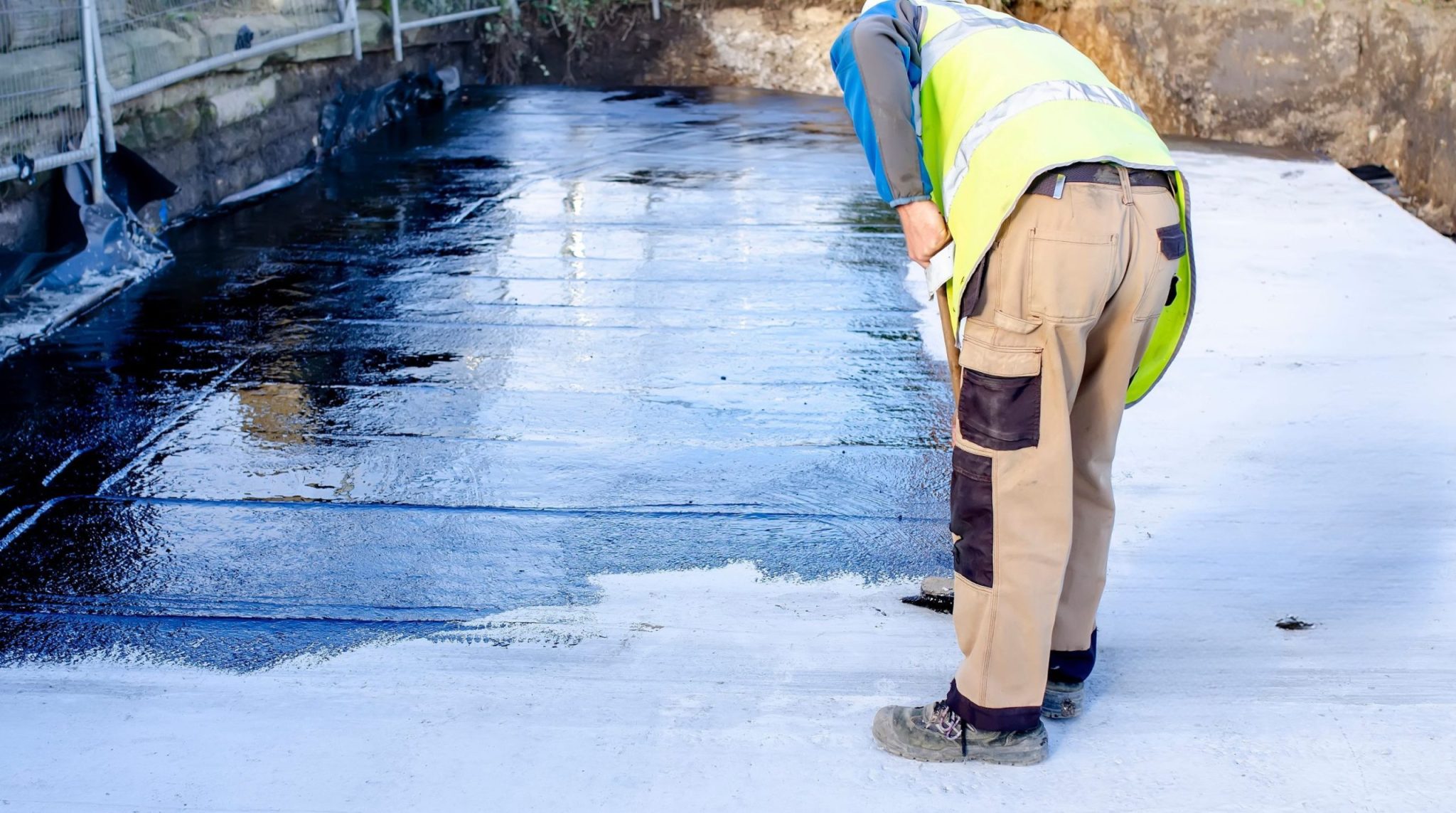 Liquid applied rubber waterproofing coating being applied on concrete roof surface in South Africa